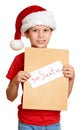 Boy in red hat with letter to santa - winter holiday christmas concept Royalty Free Stock Photo