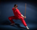 Boy in a red kimono engaged wushu