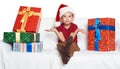 Boy in red santa helper hat with gift boxes make a wish - christmas holiday concept Royalty Free Stock Photo