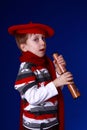 Boy in red scarf and beret with a spyglass