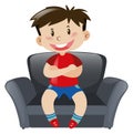 Boy in red shirt sitting on sofa