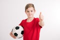 Boy in red shirt with soccer ball and thumb up Royalty Free Stock Photo