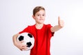 Boy in red shirt with soccer ball and thumb up Royalty Free Stock Photo