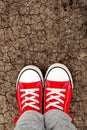 Boy in red sneakers standing on the ground, from above Royalty Free Stock Photo