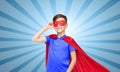 Boy in red super hero cape and mask