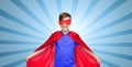 Boy in red super hero cape and mask