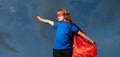 Boy in red super hero cape and mask flying. Freedom, childhood, movement and child concept. Royalty Free Stock Photo