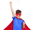 Boy in red super hero cape and mask showing fists Royalty Free Stock Photo