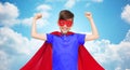 Boy in red super hero cape and mask showing fists Royalty Free Stock Photo