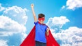 Boy in red super hero cape and mask showing fists Royalty Free Stock Photo