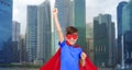 Boy in red super hero cape and mask showing fists Royalty Free Stock Photo