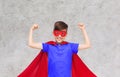 Boy in red super hero cape and mask showing fists Royalty Free Stock Photo