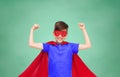 Boy in red super hero cape and mask showing fists Royalty Free Stock Photo