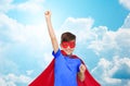 Boy in red superhero cape and mask showing fists Royalty Free Stock Photo