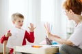 Boy in red sweater learning to count during extra-curricular activities