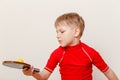 Boy in red t-shirt holding table tennis racket and ball Royalty Free Stock Photo