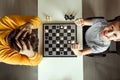 The boy rejoices in chess victory over his father. They play chess, family relationships, family. flat lay Royalty Free Stock Photo