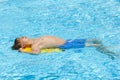 Boy relaxes on his boogie board in the pool Royalty Free Stock Photo