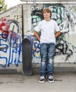 Boy relaxes with his skate board at the skate park Royalty Free Stock Photo