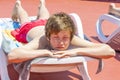 Boy relaxes on a sun lounger