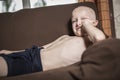 Boy relaxing on couch, teen positive laying lazy Royalty Free Stock Photo