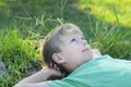 Boy relaxing on green grass lawn Royalty Free Stock Photo