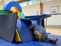 Boy relaxing in his base fort made of mats