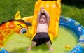 Boy relaxing in the sun on his inflatable pool