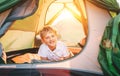 Boy rest in camping tent. Sunset time in nature Royalty Free Stock Photo