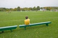 A boy rests on a bench during school soccer practice, New Hampshire