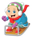 A boy ridding a sledge in winter season Royalty Free Stock Photo