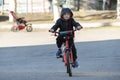 Boy rides bike around the city. Child learns to ride a bicycle