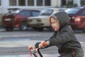 Boy rides bike in Parking lot on cars background. The safety of children