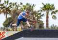 Boy rides his scooter at the skate park Royalty Free Stock Photo