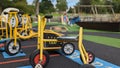 A boy rides his tricycle past a row of bikes and scooters