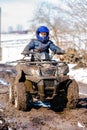 The boy is riding an ATV off-road Royalty Free Stock Photo