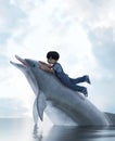 Boy riding on a dolphin Royalty Free Stock Photo