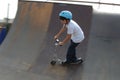 Boy riding his Scooter in a skate park against blue sky with motion Royalty Free Stock Photo