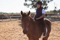 Boy riding a horse in the ranch Royalty Free Stock Photo