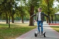 A boy riding a hoverboard in the park, a self-balancing scooter. Active lifestyle technology future Royalty Free Stock Photo