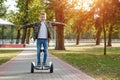 A boy riding a hoverboard in the park, a self-balancing scooter. Active lifestyle technology future Royalty Free Stock Photo
