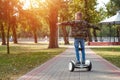 A boy riding a hoverboard in the park, a self-balancing scooter. Active lifestyle technology future Royalty Free Stock Photo