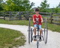 Boy Riding Old Fashioned Three Wheeled Bicycle