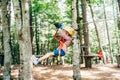 Boy riding a zip line holding on to the safety belt with his hands Royalty Free Stock Photo