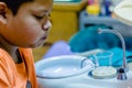 Boy rinse one`s mouth after dentist common operation of cleaning Royalty Free Stock Photo