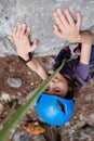 boy rock climber in a blue protective helmet overcomes the route in the mountains. children\'s sports in nature Royalty Free Stock Photo