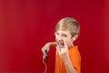 Boy rocker shouts and listens to music, heavy metals shows heavy metal gestures Royalty Free Stock Photo