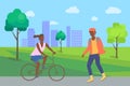 Boy Rollerblading and Woman Riding on Bike in Park Royalty Free Stock Photo