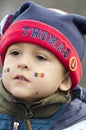 Boy with Romanian flag face-painted