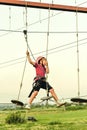 A boy on a rope overcomes obstacles in an extreme sports park